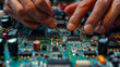 © khonkangrua - Hands of a technician soldering components on a circuit board, demonstrating technical skill and precision in electronics assembly.