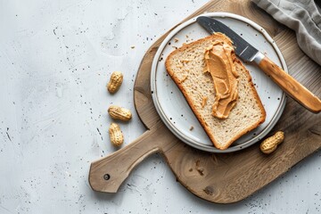 Wall Mural - Toast with peanut butter on white ceramic plate with knife on wooden cutting kitchen board, white concrete background, top view flat lay
