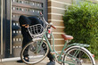 © DragonImages - Robber in black suit and sunglasses trying to steal the bike near the house