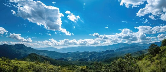 Fototapete - Scenic view with clear blue sky and fluffy white clouds, perfect for a copy space image.