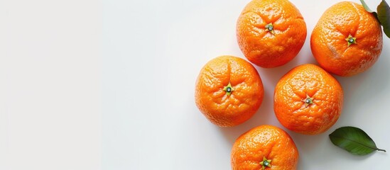 Poster - Top view image of four ripe mandarins isolated on white background with space for text, perfect for fruit and agriculture concepts. copy space available