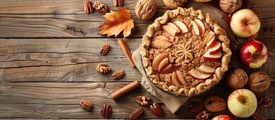 Poster - Delicious homemade whole wheat pie with apples, cinnamon, and a variety of nuts on a rustic wooden table with copy space image.