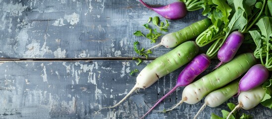 Poster - Top view of green and purple daikon radishes placed on a gray wooden surface, with room for text in the image. copy space available