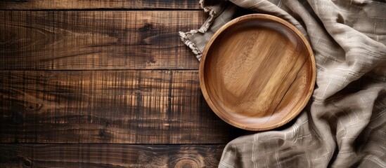 Aufkleber - Brown wooden desk with a wooden plate and linen napkin, providing a rustic aesthetic and a lovely setting with copy space image.