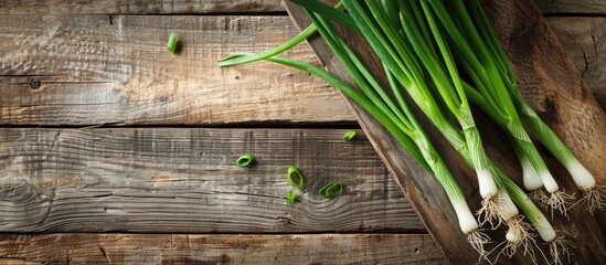 Poster - Fresh, vibrant green onions displayed on a wooden board with copy space image.