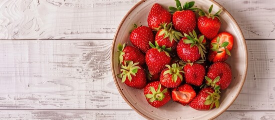 Aufkleber - A stylish plate with delicious fresh strawberries atop a white wooden backdrop, captured from above with a copy space image.