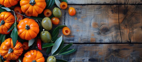 Poster - Festive Thanksgiving theme with vivid pumpkins and olives arranged on a wooden surface for a flat lay and top view, providing ample copy space in the image.