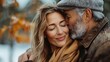 © Pinklife - A senior couple enjoying a content moment together in the outdoors, characterized by a tender embrace in an autumn setting, both dressed warmly and feeling serene.