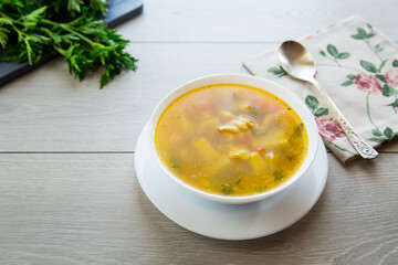 Wall Mural - Homemade chicken vegetable soup on rustic wooden background