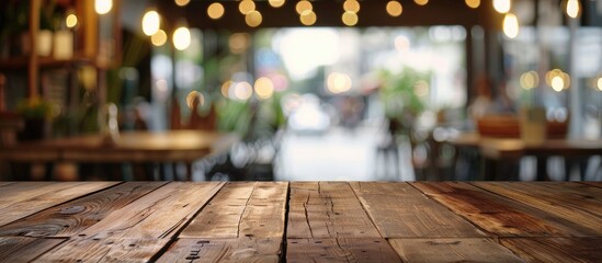 Fototapete - Brown wooden table with blur background at a cafe, perfect for product display montage with copy space image.