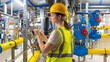 © Grispb - Woman factory technologist. Chemical plant. Girl engineer in gas boiler room. Woman in room with industrial pipes. Technologist at chemical plant. Factory contractor. Factory technologist with tablet