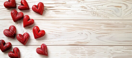 Poster - Copy space image featuring red hearts on a light wooden backdrop.