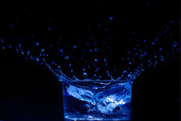 Wall Mural - water splash isolated on the black background