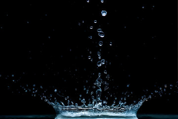 Wall Mural - water splash isolated on the black background