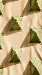 Poster - Symmetrical Array of Green Tents on Beige Background in Sun-Drenched Scene