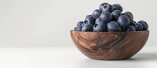Poster - A wooden bowl filled with blueberries displayed on a white backdrop with space for additional imagery.