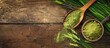 © StockKing - A wooden background showcasing barley grass powder, fresh blades, and room for a copy space image.