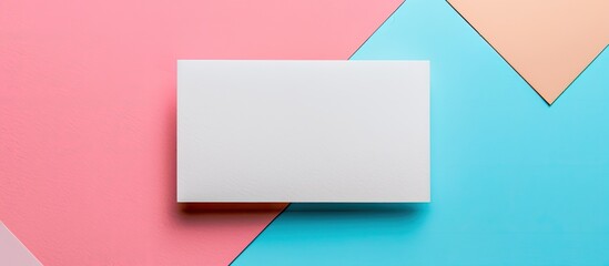 Aufkleber - A blank business card mockup on a colored background in a flat lay style with designated copy space image.