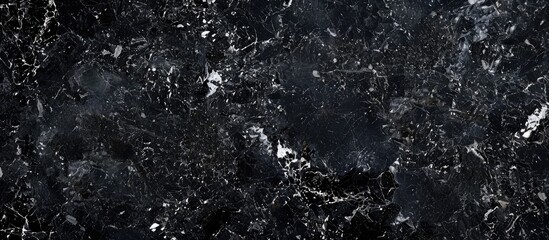 A close-up black marble slab with a granite texture featuring a grainy rock surface design, ideal for construction industry layouts with copy space image.