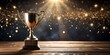 © Tekin - low key image of trophy over wooden table and dark background, with abstract shiny lights