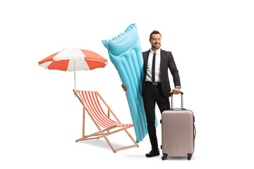 Wall Mural - Businessman holding a water floating mattress and a suitcase next to a beach chair