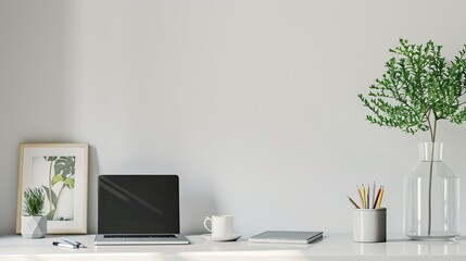 A white desk with a black coffee mug, a framed picture, a tablet, and a plant in a vase