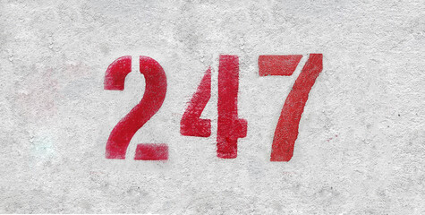 Red Number 247 on the white wall. Spray paint.