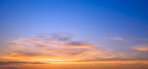 sunset sky with golden sunlight and orange clouds on horizon blue evening sky background after sundo