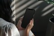© CogniLens - Display mockup from a shoulder angle of a girl holding an smartphone with an entirely black screen