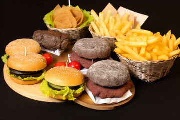 Wall Mural - Hamburger and french fries on a black background, fast food