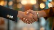© YURY YUTY - Close-up of a handshake between two professionals, symbolizing a successful business agreement.