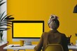 © CogniLens - Ui mockup through a shoulder view of a mature woman in front of a computer with a fully yellow screen