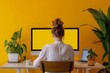 © CogniLens - Ui mockup through a shoulder view of a mature woman in front of a computer with a fully yellow screen