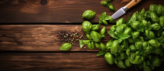 Wall Mural - Top view of fresh green basil and vintage herb chopper on a rustic wooden board, with horizontal composition and ample copy space image.
