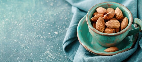 Wall Mural - Copy space image of an almond in a ceramic cup set on a blue napkin.