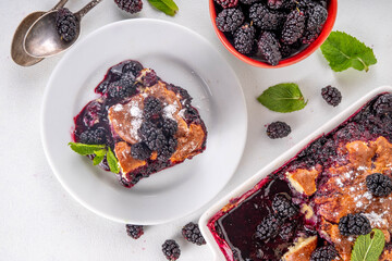 Wall Mural - Sweet homemade mulberry cobbler pie, Sweet summer berry cobbler cake in enamel baking dish and plate, on white kitchen table copy space 