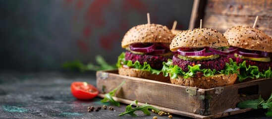 Wall Mural - Vegan beet chickpea burgers with vegetables, guacamole and rye buns in wooden box. Healthy vegan food concept. Copy space image. Place for adding text or design