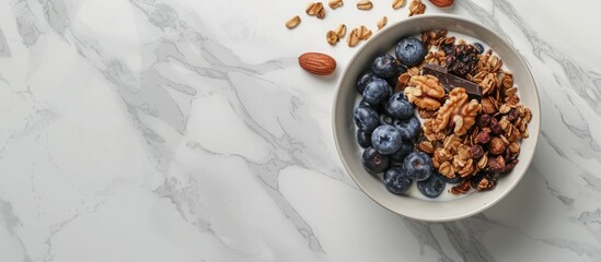 Aufkleber - Granola, dark chocolate, nuts, blueberries in a bowl placed on a white marble surface providing a healthy breakfast option. Seen from top with space for text in the image. with copy space image