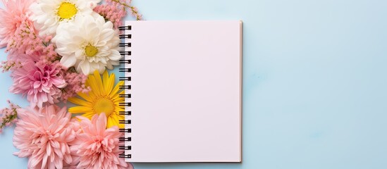 Poster - Colorful background with a blank notebook, pen, and flowers, perfect for adding text or graphics in the copy space image.