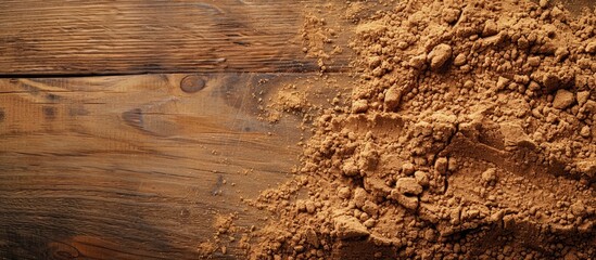 Leinwandbilder - Close-up of fragrant ground cinnamon powder on a textured wooden background, perfect for baking, desserts, and drinks, with available space for text or images. with copy space image