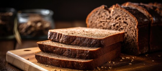 Poster - Close-up of sliced homemade rye bread on a cutting board with copy space image.