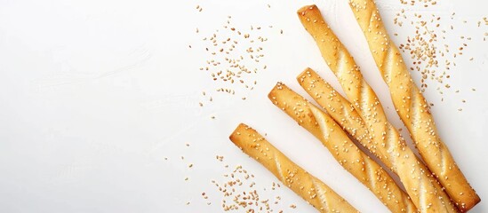 Poster - Crispy sesame sticks on a white backdrop with elongated shape, classified as bread and flour products, known for being healthy snacks with a copy space image.