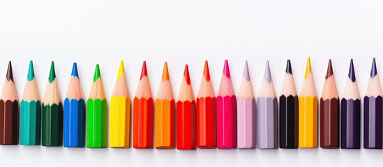 Poster - Color pencils held against a white backdrop with a creative scene for a copy space image.