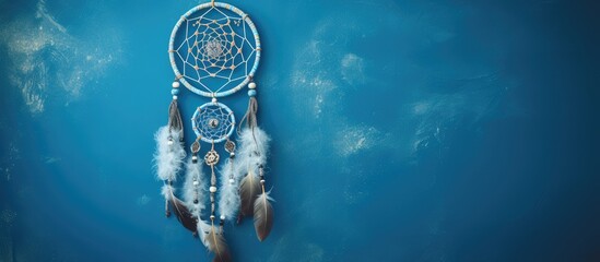 Top view of a dream catcher feature Asian attributes on a blue background with copy space image available.