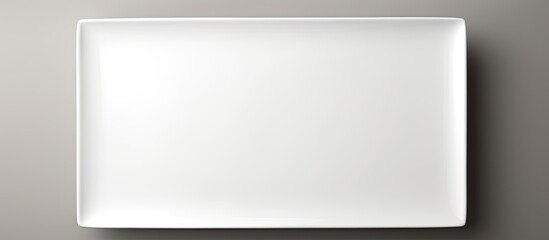 Wall Mural - Rectangular white ceramic plate on a white backdrop with copy space image.