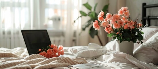 Aufkleber - Begonia flowers, laptop and magazine on table near bed in light room. with copy space image. Place for adding text or design