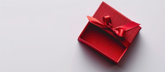 Poster - A red gift box on a white backdrop with copy space image.