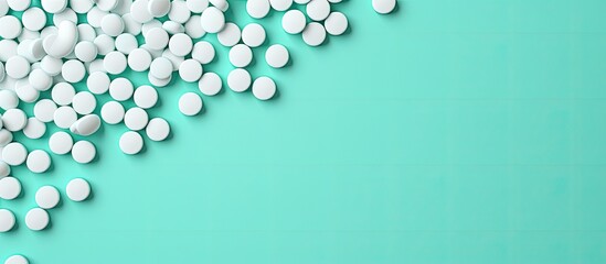 Wall Mural - Mint background adorned with white pills in a flat lay composition, with room for text in the image. with copy space image. Place for adding text or design