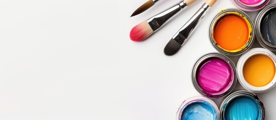 Poster - Colorful gouache paint cans and artist brushes displayed on a white background with copy space image.