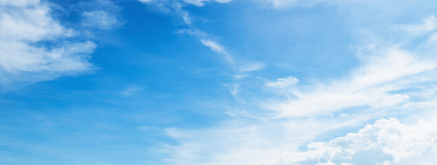 clear blue sky with a few clouds. the sky is very bright and the clouds are scattered throughout